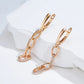 Boucles d'oreilles pendantes anneaux et zircons, bijou en plaqué or rose et en zircons naturels
